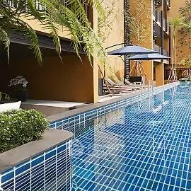 Luxurious poolside area with modern design and relaxing lounge chairs.