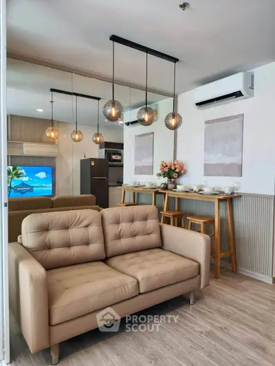 Modern living room with stylish pendant lights and cozy beige sofa