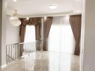 Elegant living room with chandelier and floor-to-ceiling windows, featuring luxurious curtains and glossy flooring.