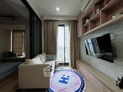 Chic modern living room with city view, cozy sofa, and stylish decor.