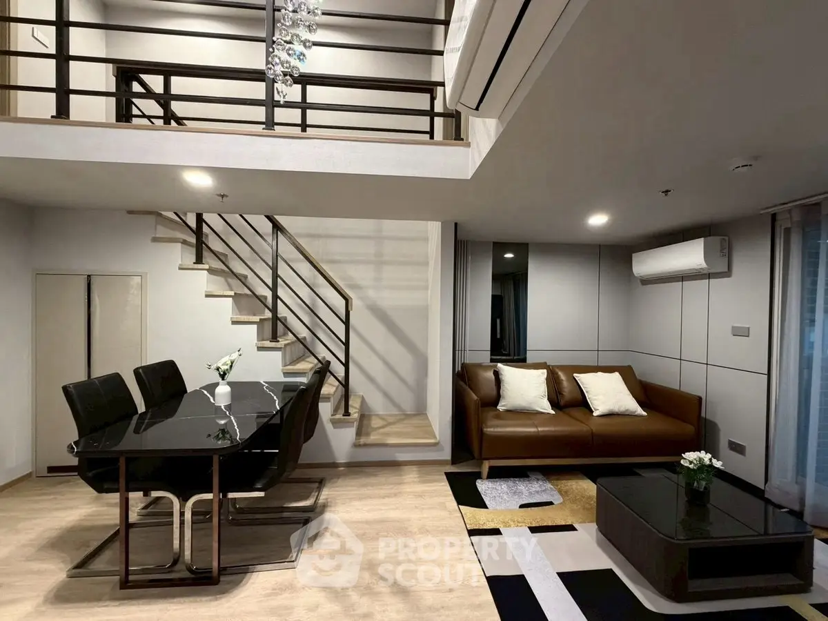 Modern duplex living room with stylish furniture and elegant staircase