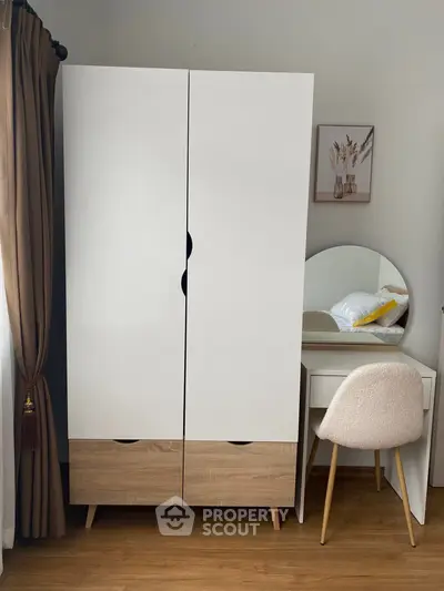 Modern bedroom with stylish wardrobe and cozy vanity setup.