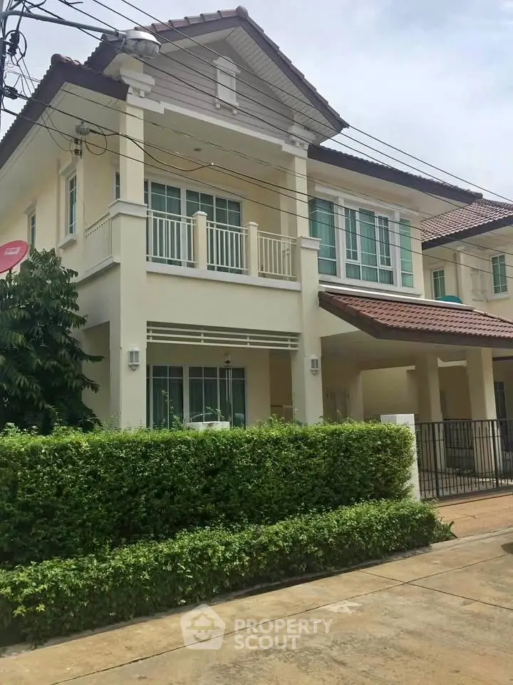 Charming two-story house with lush greenery and modern design