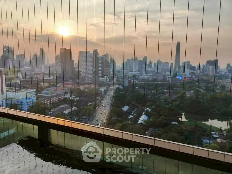 Stunning city skyline view from a high-rise balcony at sunset, perfect for urban living.