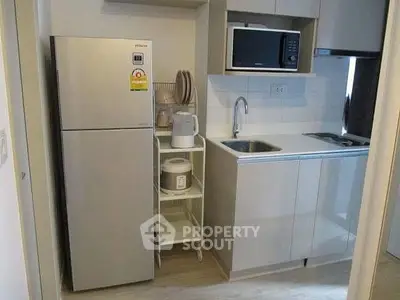 Modern compact kitchen with sleek appliances and efficient storage solutions.