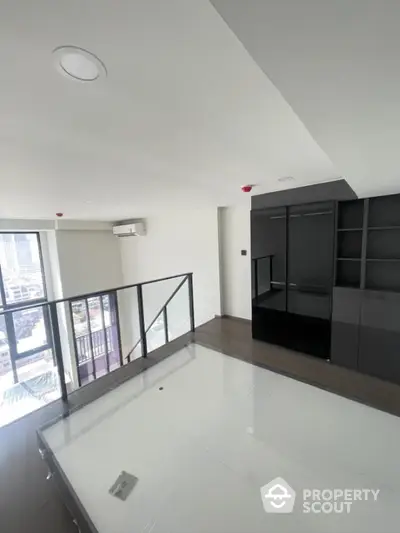 Modern loft apartment with sleek design and city view, featuring large windows and stylish interior.