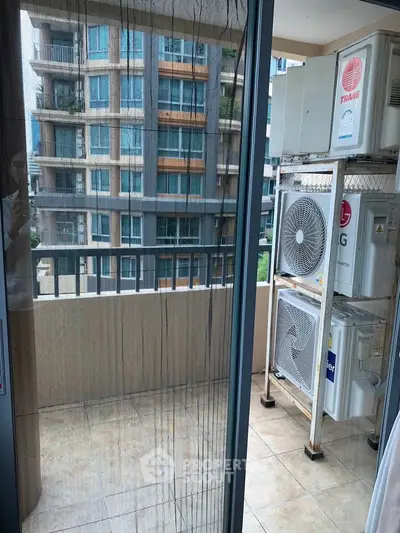 Modern balcony with air conditioning units and city view