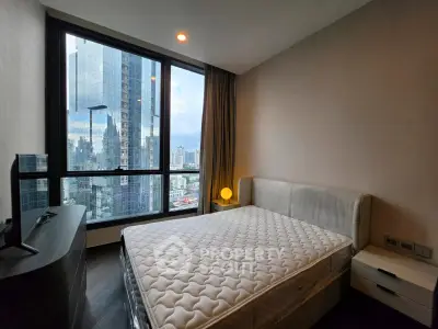 Modern bedroom with city view in high-rise apartment
