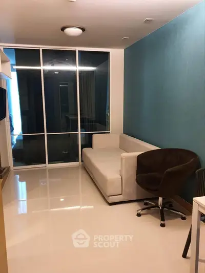 Modern living room with sleek design and comfortable seating in a stylish apartment.