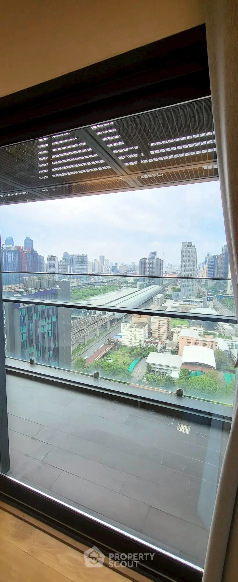 Stunning cityscape view from a modern high-rise balcony, perfect for urban living.