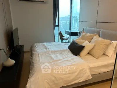 Modern bedroom with large window and city view, featuring cozy bed and stylish decor.