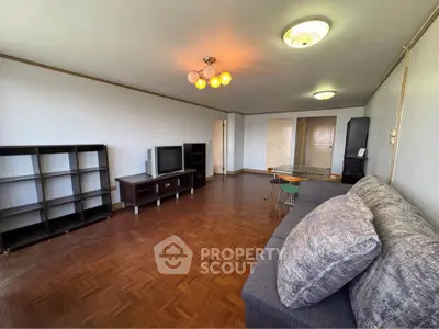 Spacious living room with parquet flooring and modern furnishings