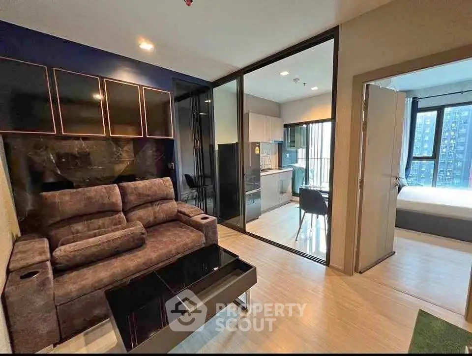 Modern apartment interior with cozy living room and open kitchen layout, featuring stylish furniture and natural light.