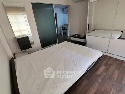 Spacious bedroom with modern design and wooden flooring