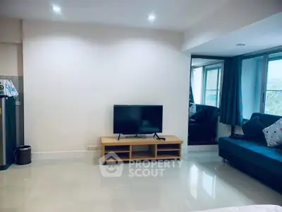 Spacious living room with modern TV setup and cozy seating area