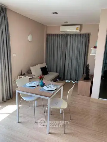 Cozy living room with modern decor and dining area in stylish apartment.