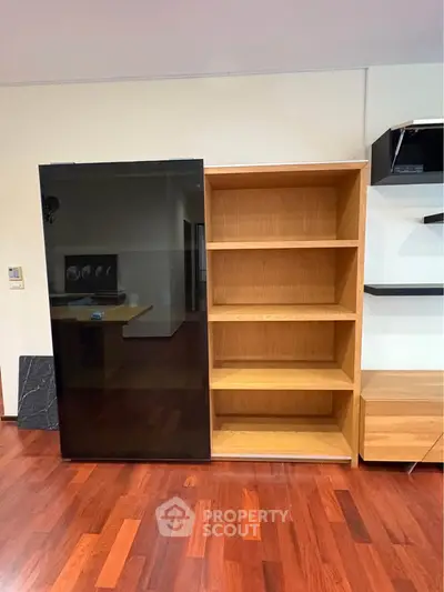 Modern interior with sleek wooden shelving and polished hardwood floors.