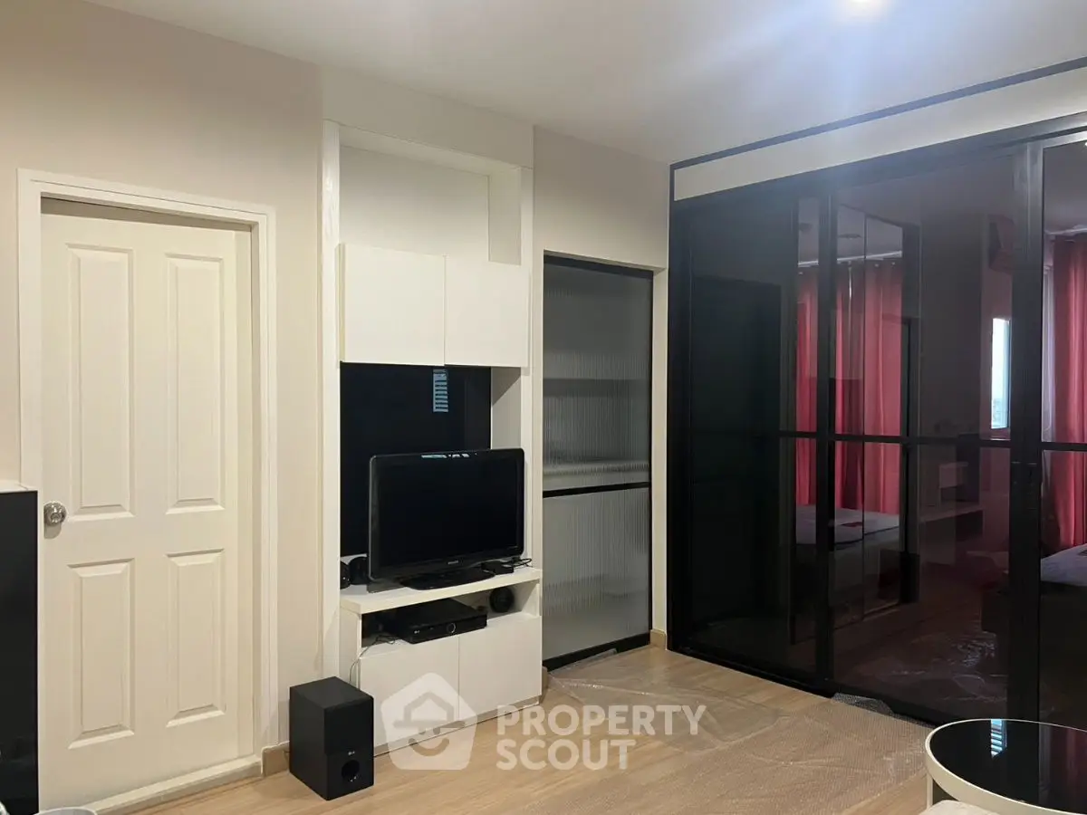 Modern living room with sleek black glass wardrobe and entertainment center.