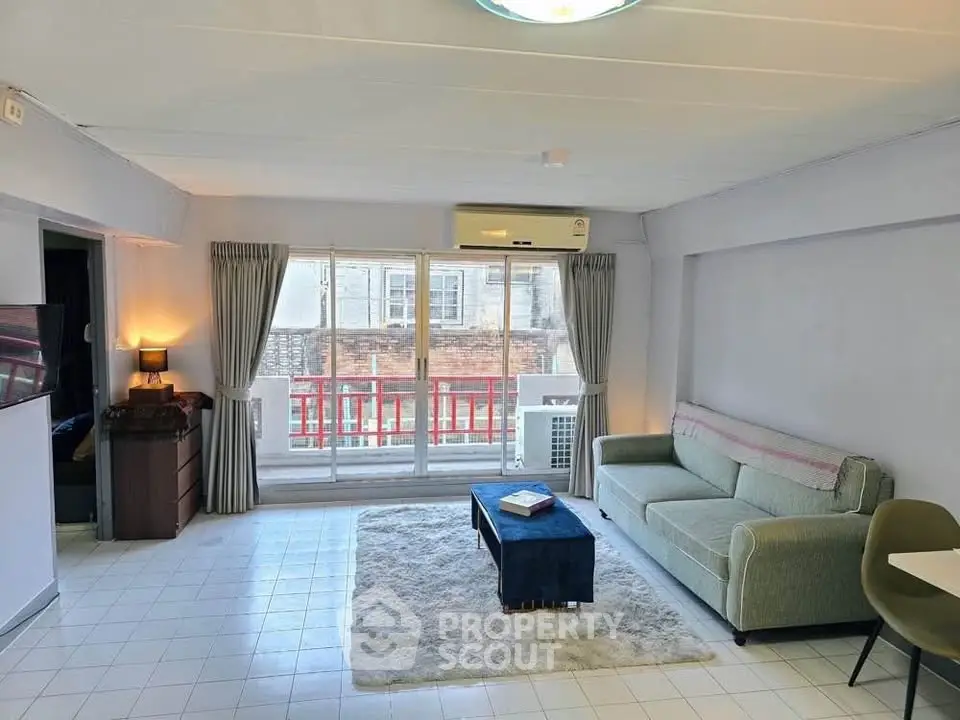 Spacious living room with modern decor and large windows in a stylish apartment.