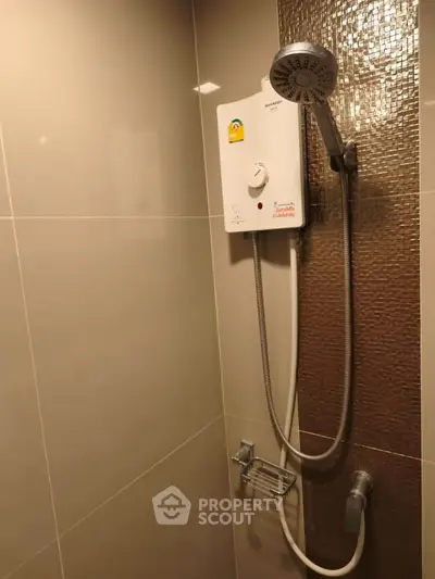 Modern bathroom with sleek shower unit and elegant tile design.