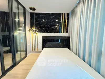 Luxurious modern bedroom with elegant black and gold accents and floor-to-ceiling windows.