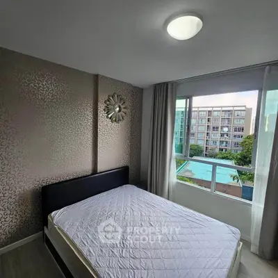 Modern bedroom with large window offering pool view in stylish apartment