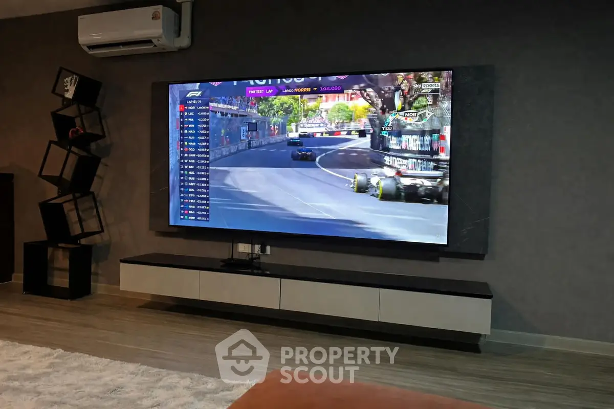 Modern living room with large TV and stylish shelving unit