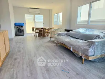 Spacious modern living room with sleek flooring and natural light