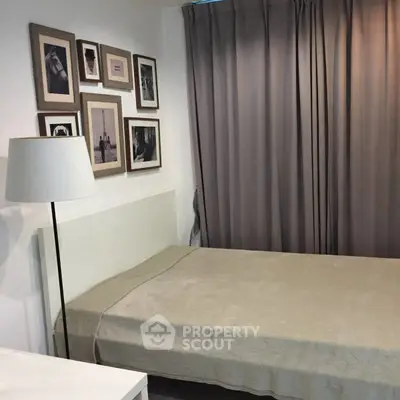 Cozy bedroom with single bed and framed wall art, ideal for minimalist living.