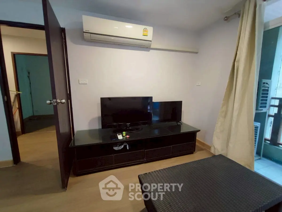 Cozy living room with air conditioning and modern TV setup