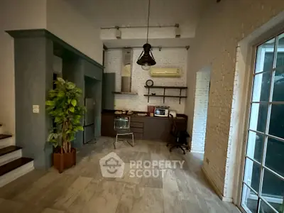 Charming industrial-style living space with exposed brick and modern kitchen amenities.