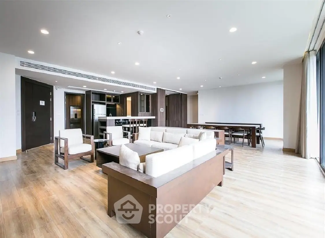 Spacious modern living room with open kitchen and elegant wooden flooring