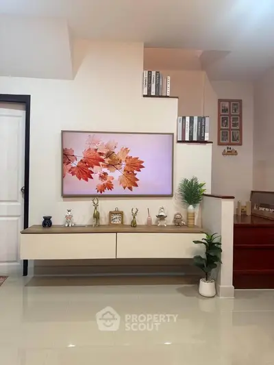 Modern living room with stylish decor and wall-mounted TV, showcasing elegant interior design.