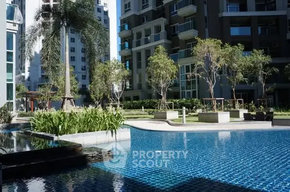 Luxurious residential complex with a stunning outdoor pool and lush greenery.