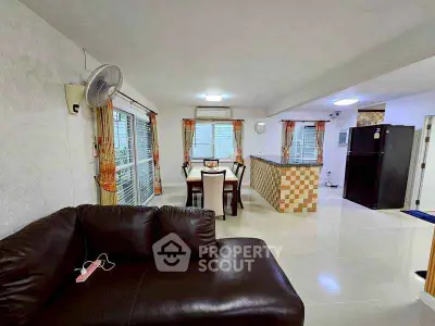 Spacious open-plan living and dining area with modern furnishings and ample natural light.