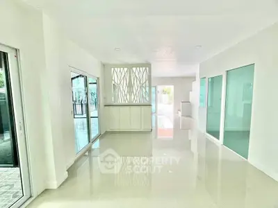 Spacious modern living area with glossy floors and large windows