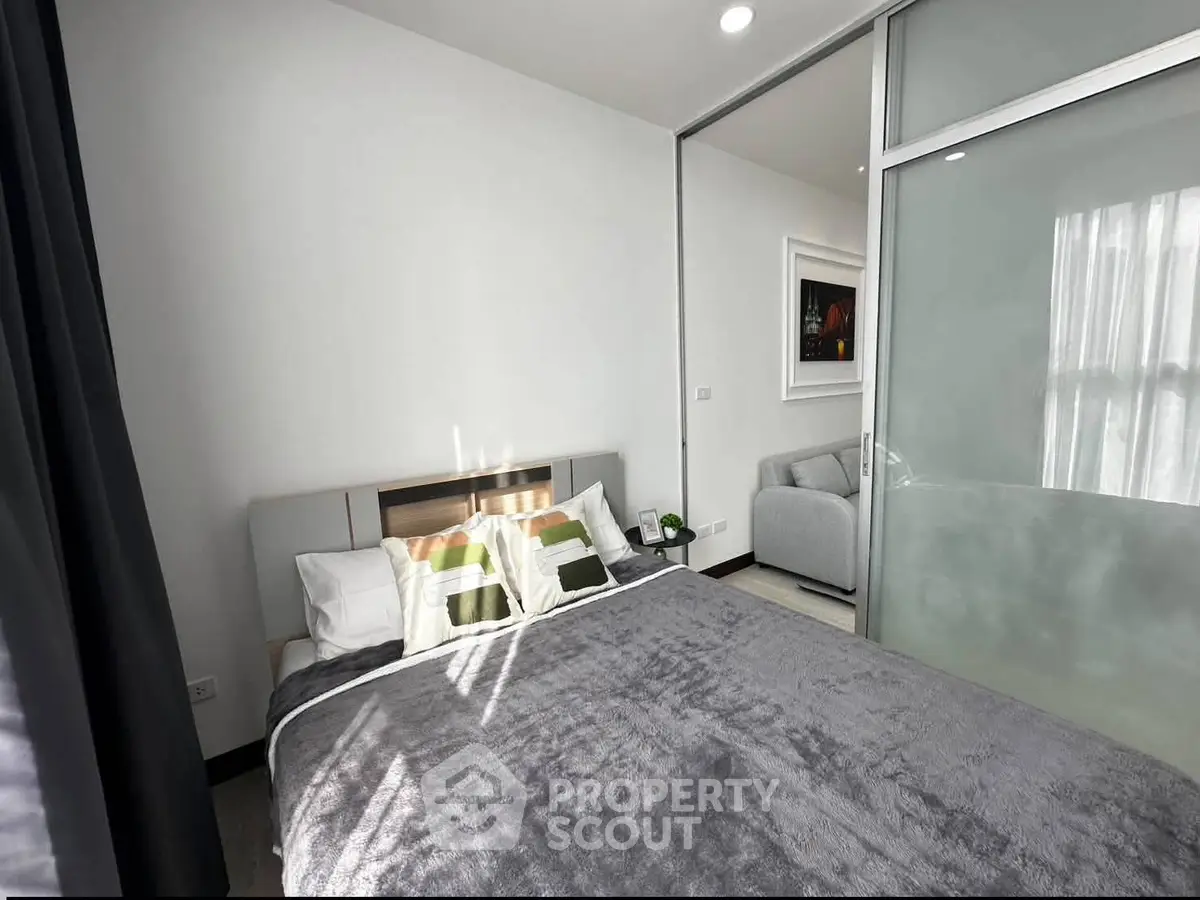 Modern bedroom with sliding glass doors and cozy decor