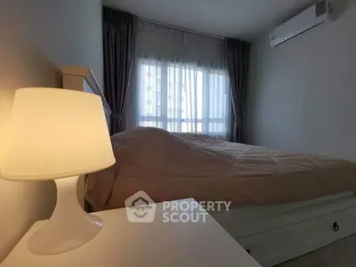 Cozy bedroom with modern air conditioning and soft lighting, perfect for relaxation.