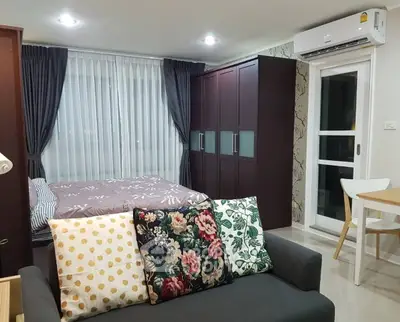 Modern studio apartment with cozy living area and stylish decor