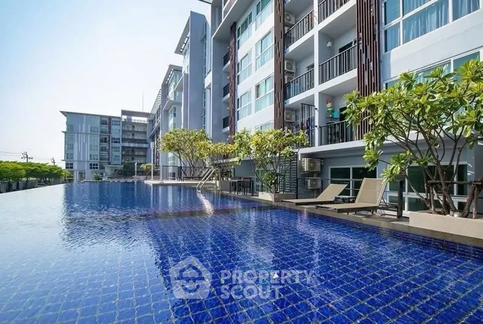 Luxurious condominium with stunning pool and modern architecture, perfect for relaxation and leisure.
