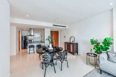 Modern open-plan living and dining area with sleek kitchen and stylish decor.