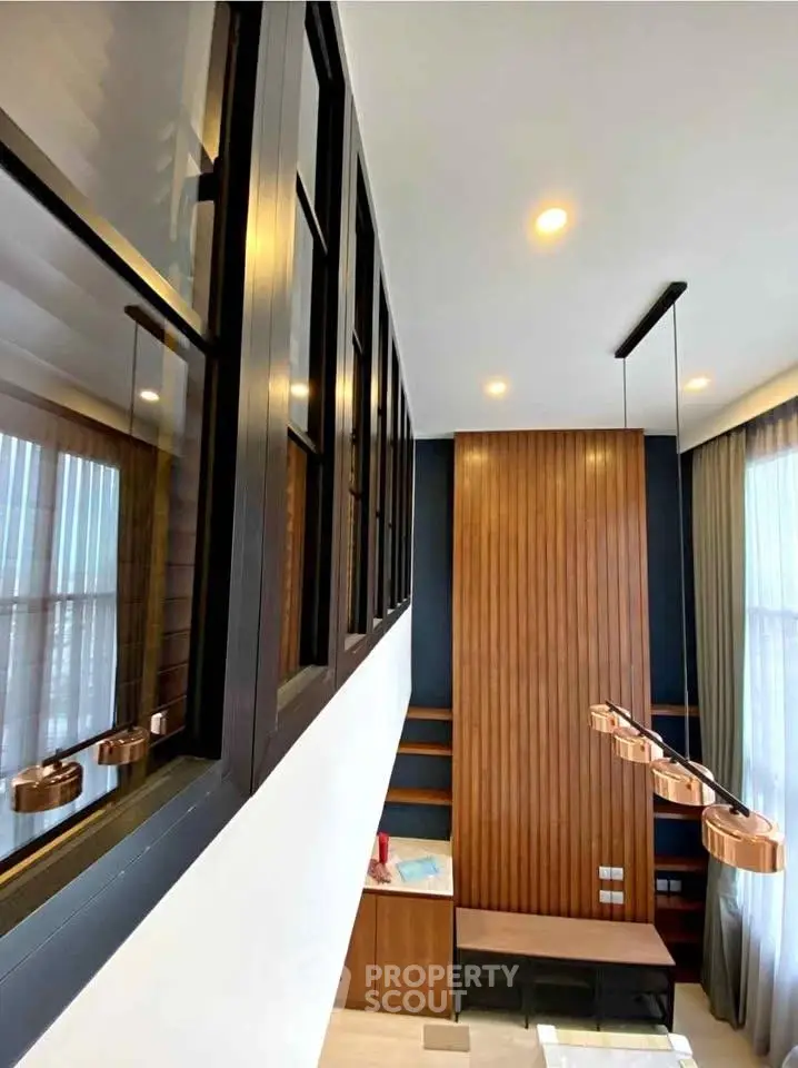 Modern living room with high ceiling and stylish lighting fixtures