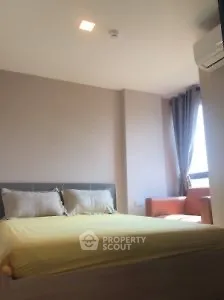 Cozy bedroom with natural light and modern furnishings in a stylish apartment.