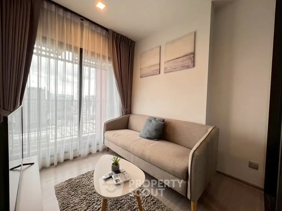Cozy living room with modern sofa and large window offering city view