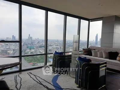 Luxurious living room with panoramic city view in high-rise apartment
