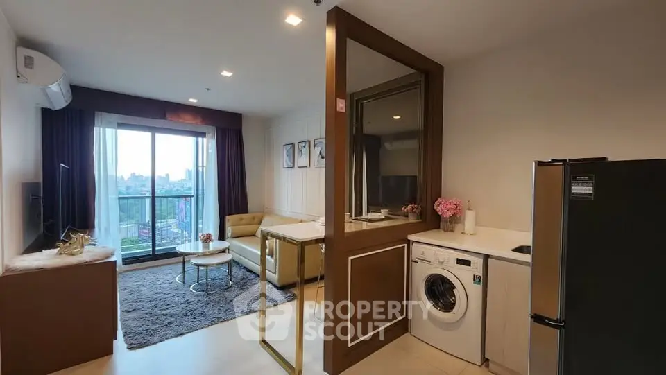 Modern living room with balcony view, stylish furniture, and in-unit washing machine in a chic apartment.