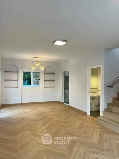 Spacious modern living room with wooden flooring and elegant lighting