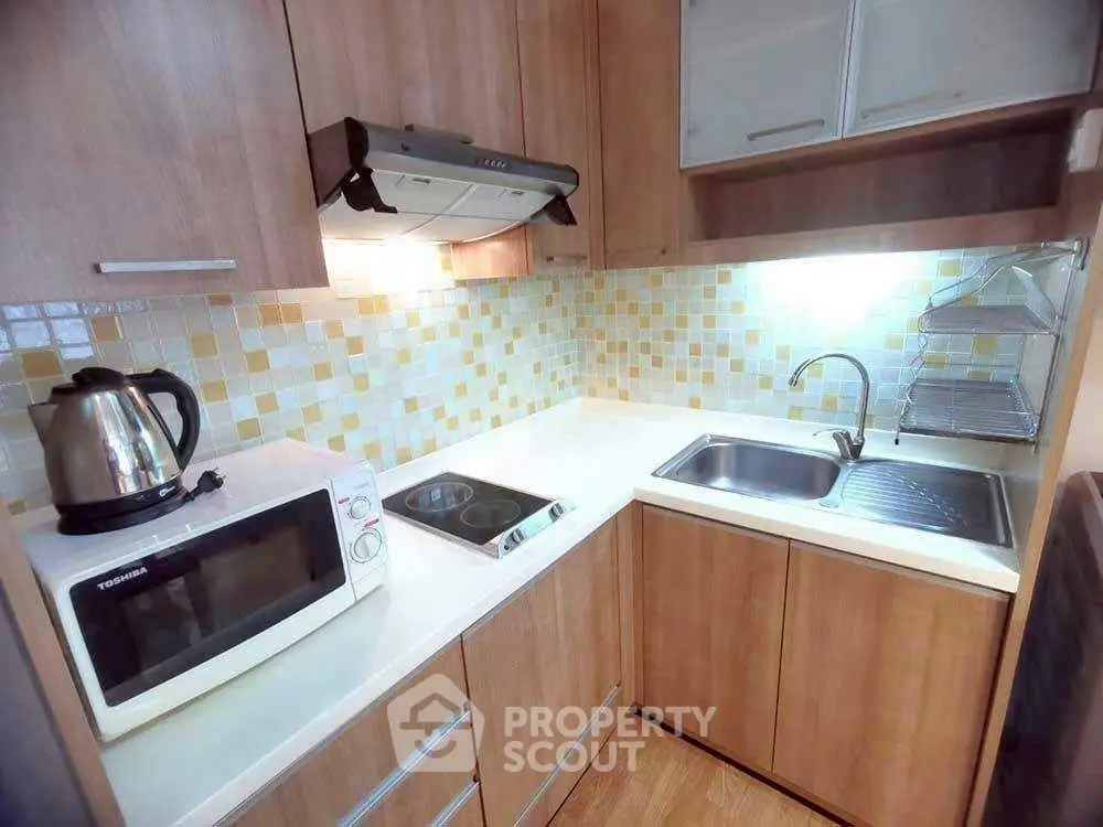Compact modern kitchen with wooden cabinets and tiled backsplash