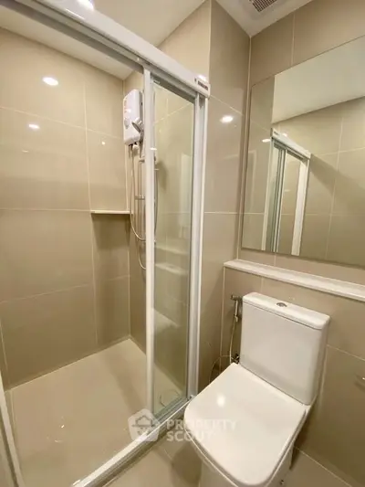 Modern bathroom with glass shower enclosure and sleek toilet design.