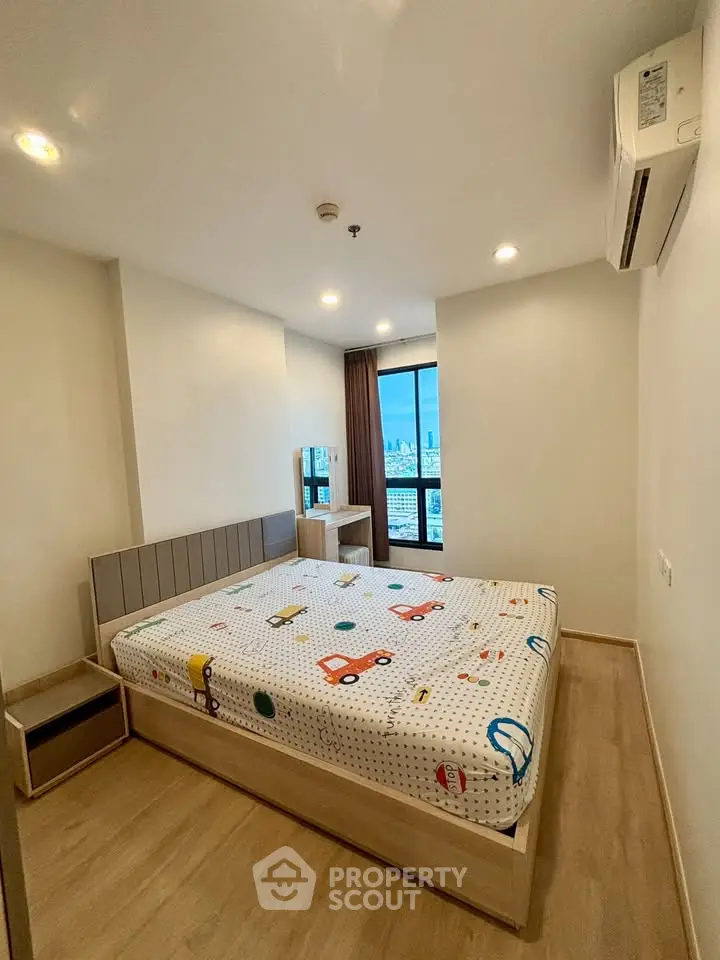 Modern bedroom with city view, featuring stylish decor and ample natural light.